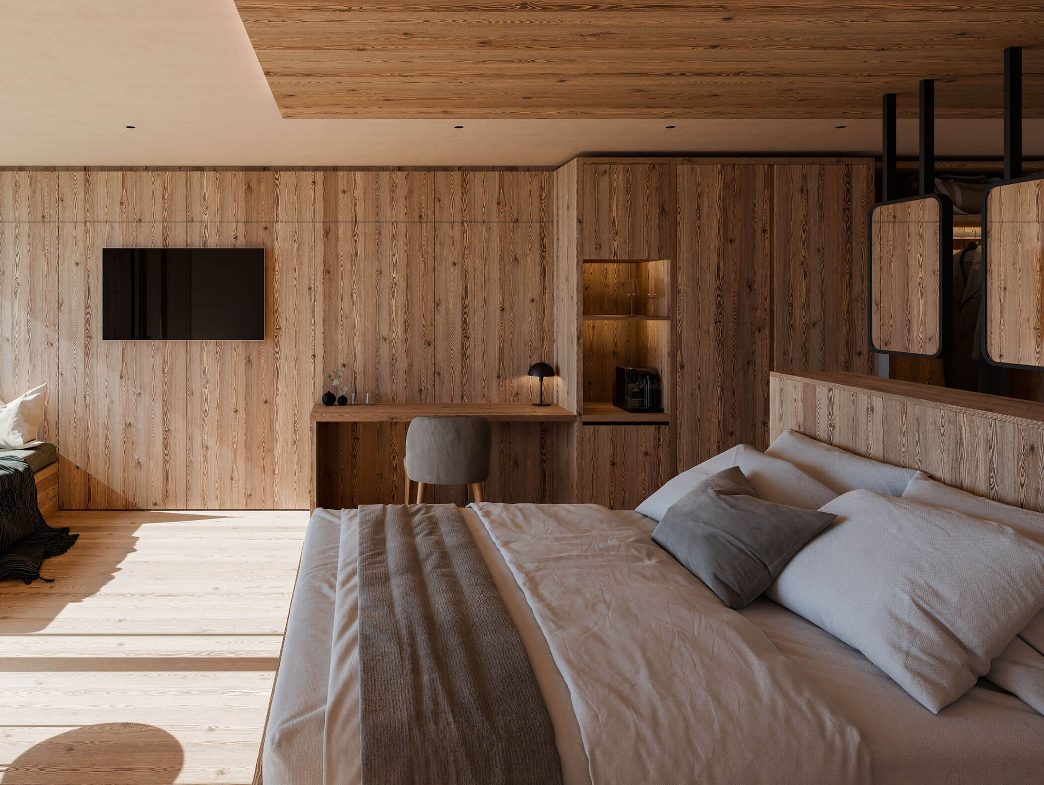 Camera da letto moderna con pareti rivestite in legno, grande letto, scrivania e scaffali a muro sotto una morbida illuminazione naturale. - Hotel Moosmair