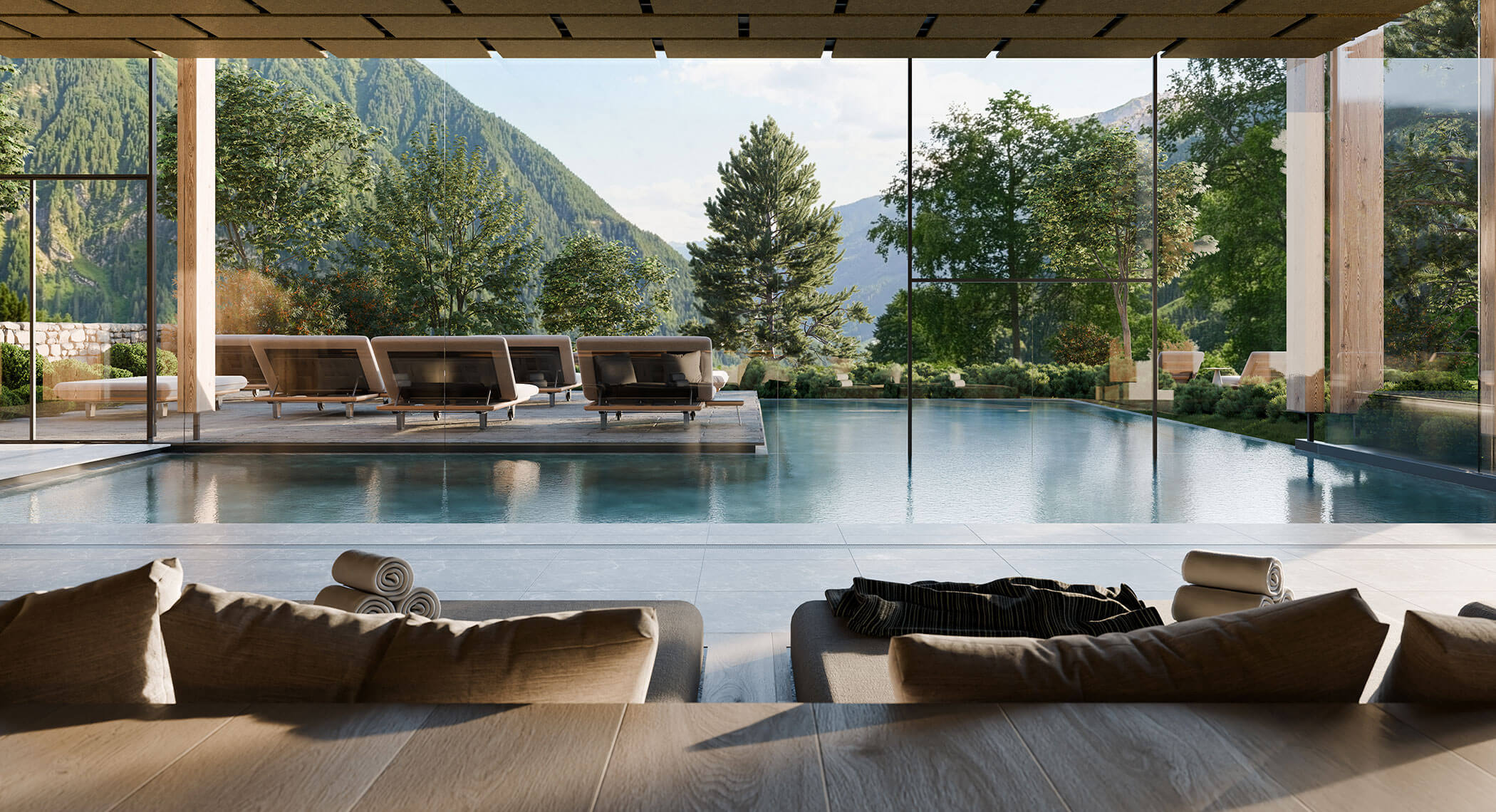 Lussuosa piscina coperta con sedie a sdraio, ampie finestre e una vista panoramica sulle montagne circondata da alberi. - Hotel Moosmair